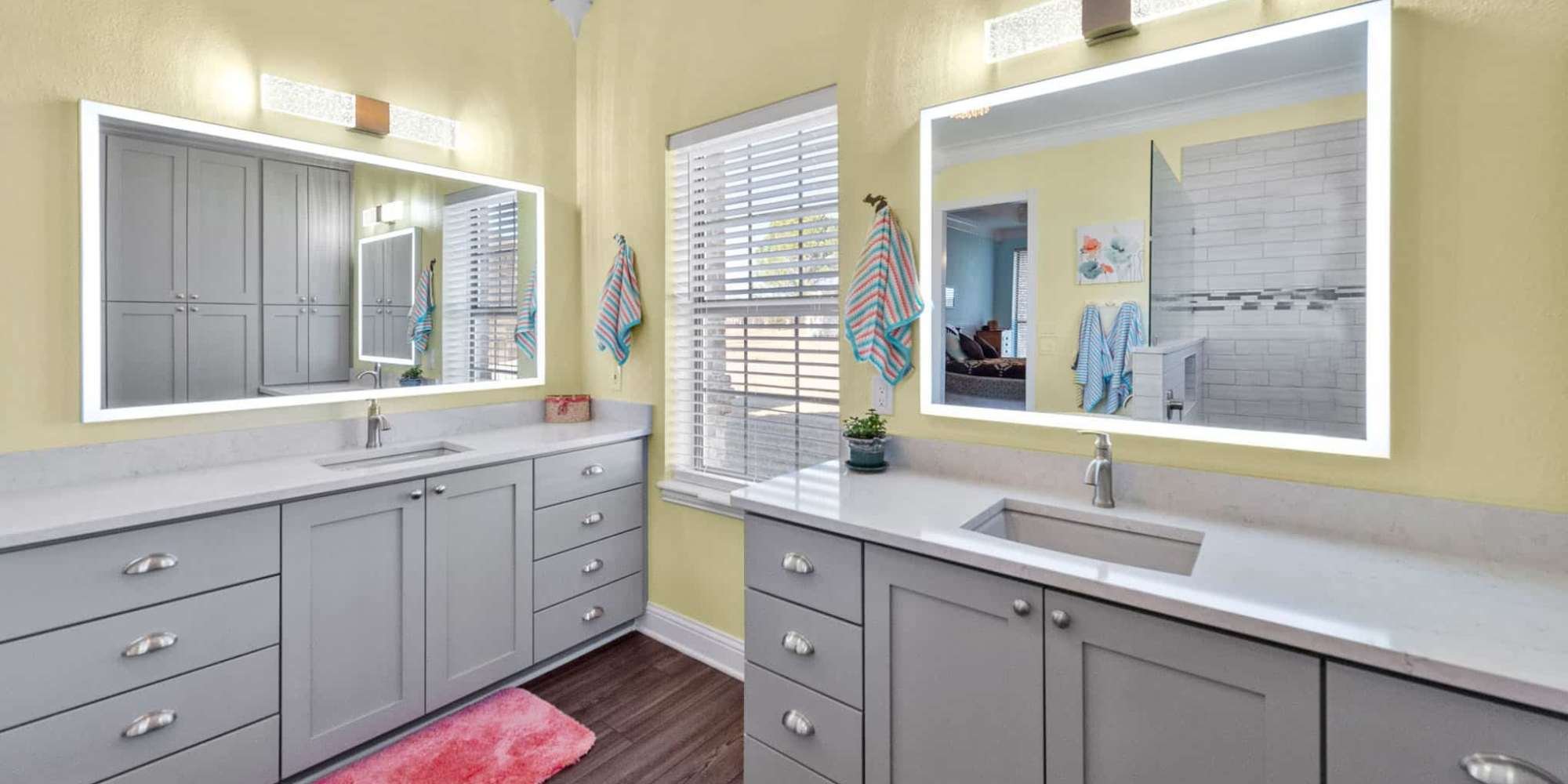 Image of bathroom remodel with double vanity, lighted mirrors, and modern finishes in Collin County by Elite Remodeling