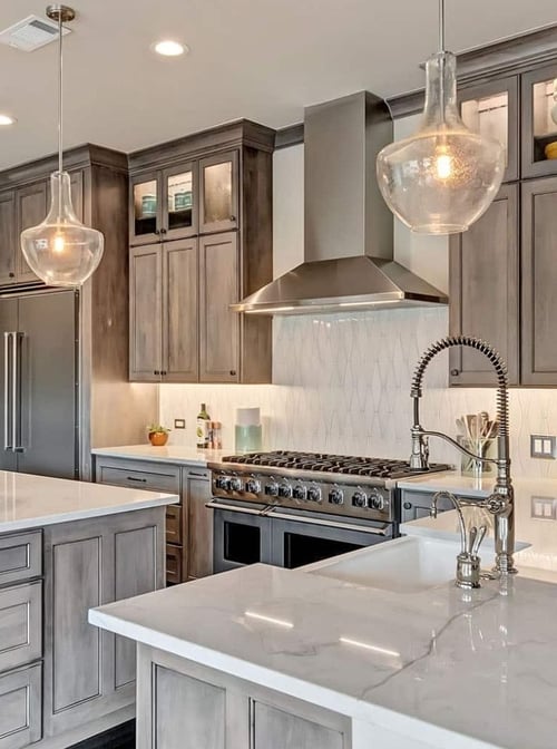 Texas kitchen remodel featuring marble countertops overhead light fixtures by Elite Remodeling