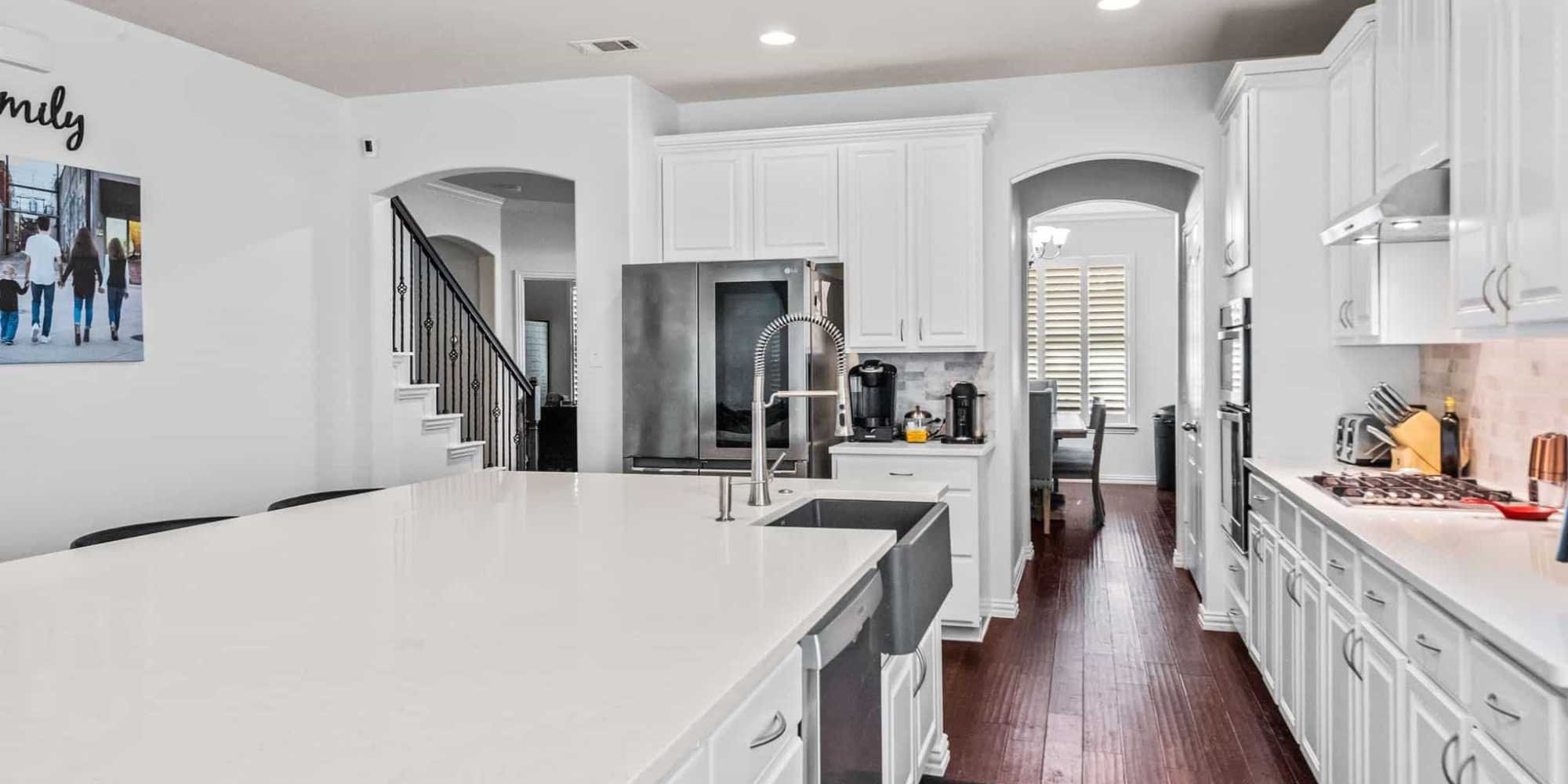 Image of an open-concept kitchen remodel with large kitchen island and custom cabinets in Frisco, TX