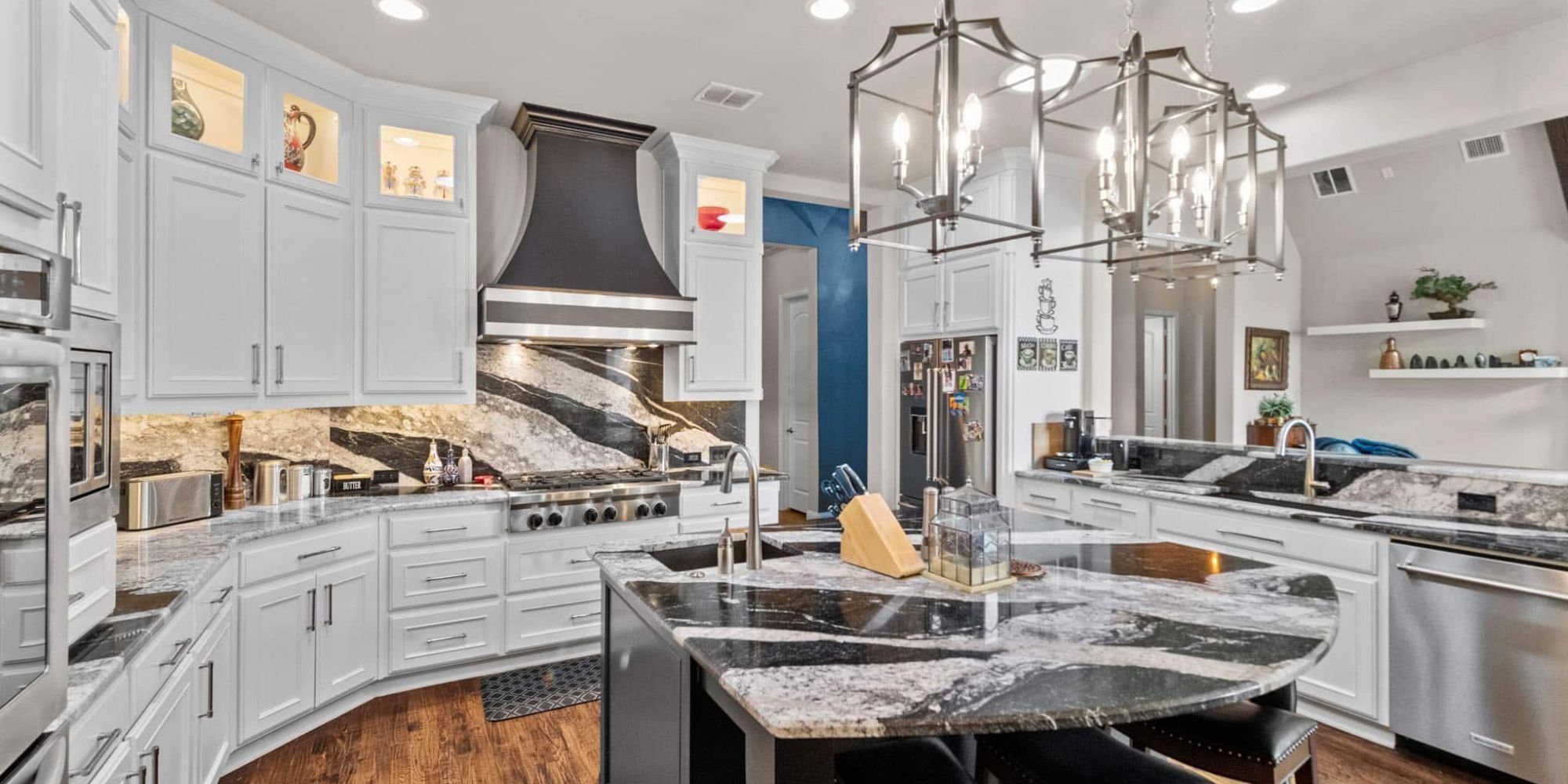 Elite Remodeling kitchen renovation in Frisco, TX with dramatic stone island and pendant lighting