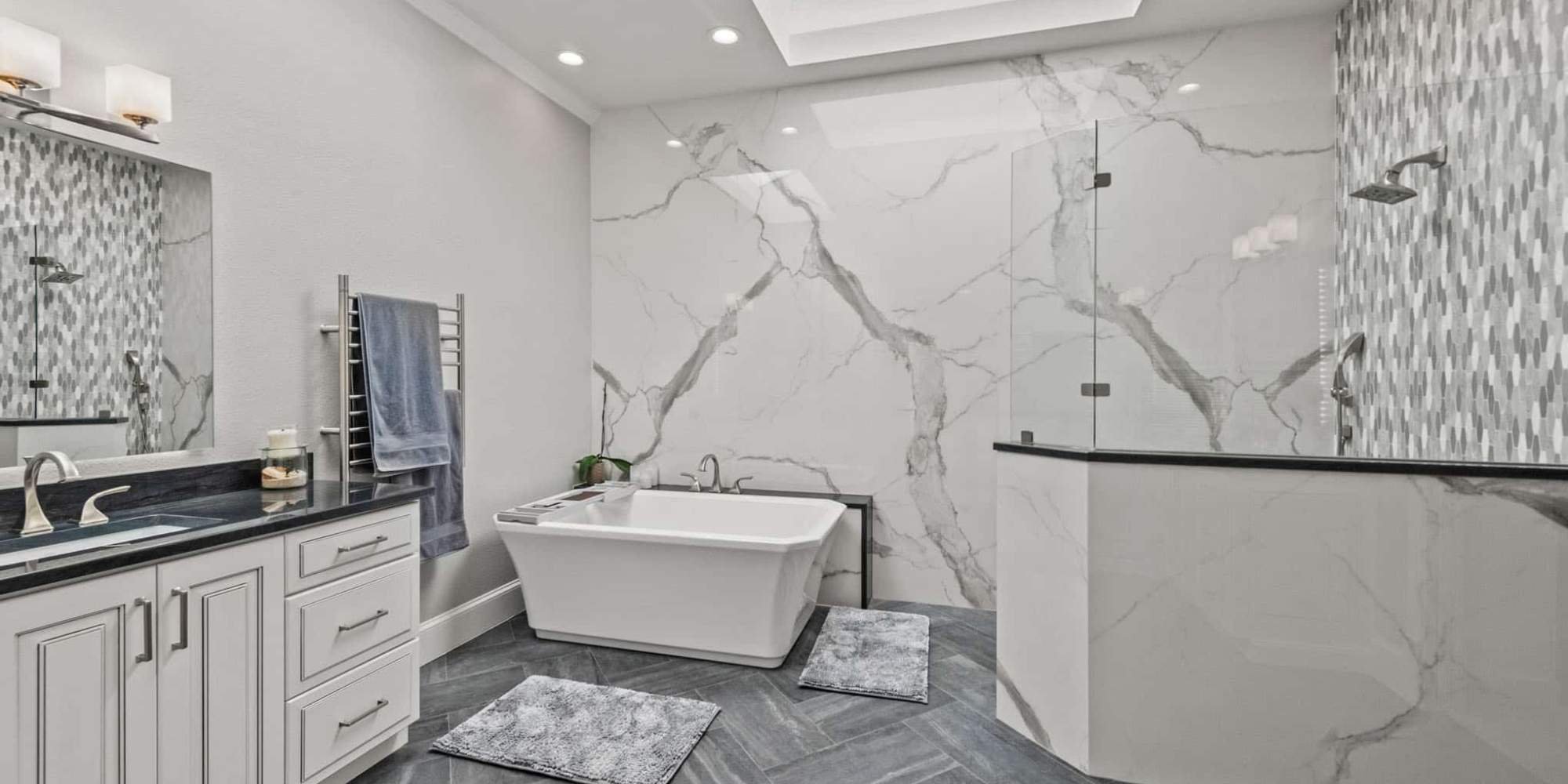 Elite Remodeling master bath in Frisco, TX with soaking tub, walk-in shower, and marble wall tile