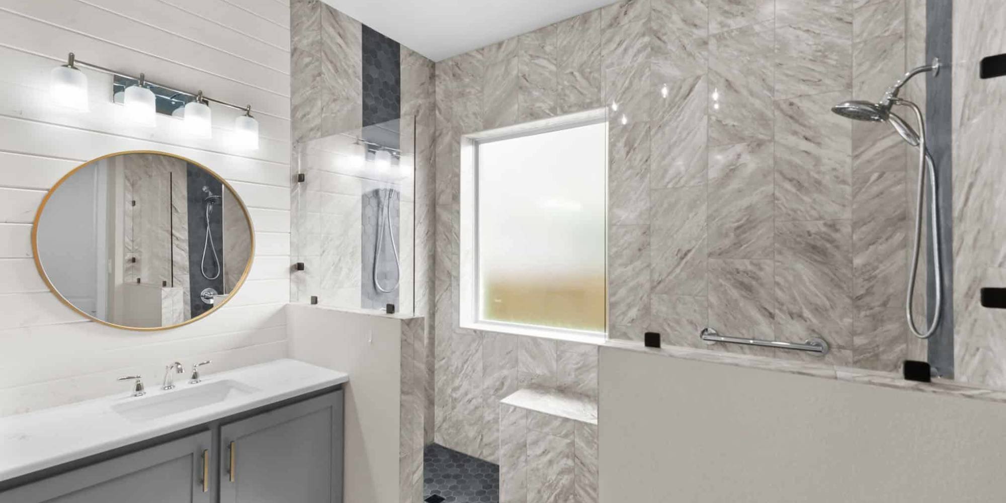 Neutral-toned master bathroom remodel in Frisco by Elite Remodeling with elegant gray tile and soft lighting