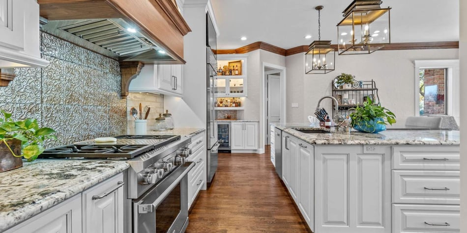 Elite Remodeling kitchen in Frisco, TX with ornate backsplash, granite counters, and custom cabinetry