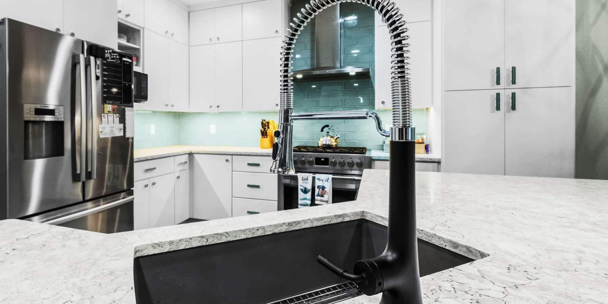 Frisco kitchen renovation featuring sleek white cabinets and blue tile backsplash by Elite Remodeling