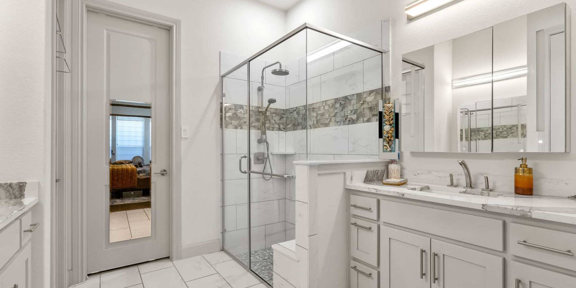 Modern bathroom remodel in Frisco, TX showcasing sleek cabinetry and a walk-in glass shower by Elite Remodeling