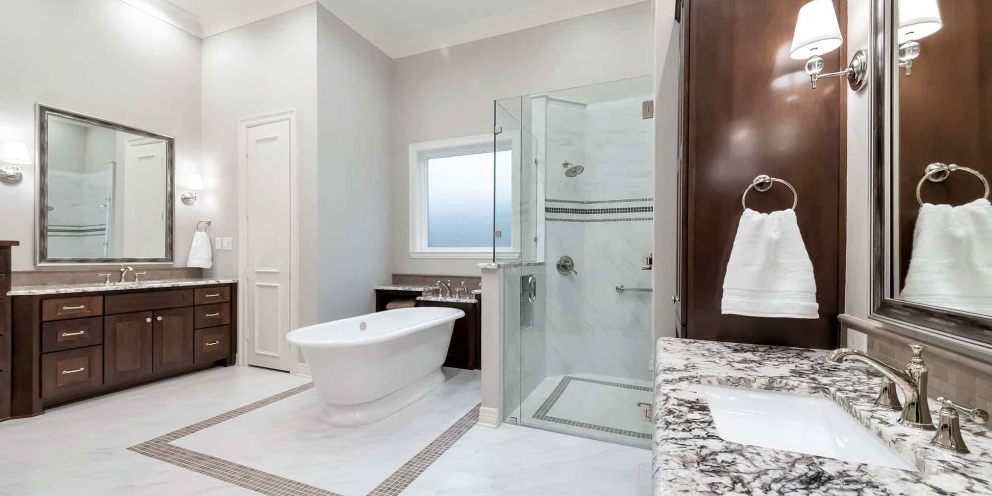 Spacious bathroom remodel in Frisco, TX with dual sinks and freestanding tub by Elite Remodeling