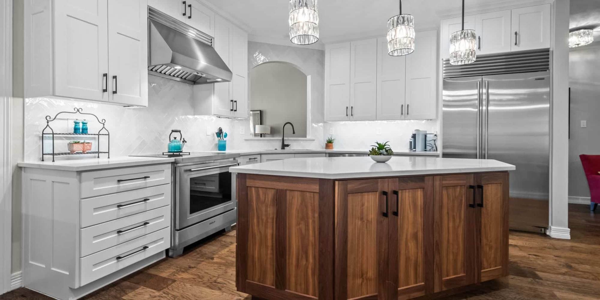 Two-tone shaker kitchen cabinets with white uppers and walnut island by Elite Remodeling in Collin County, Texas
