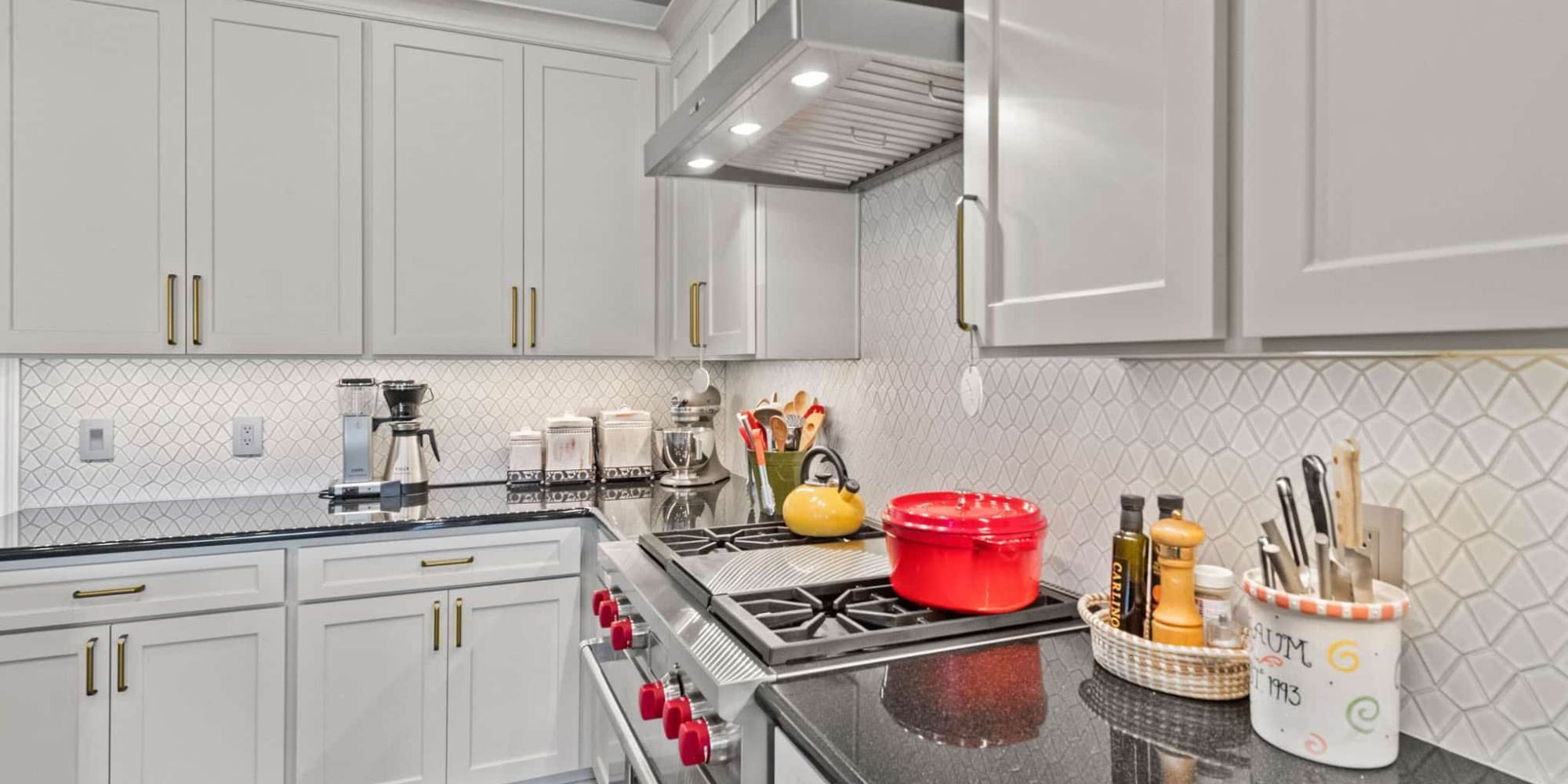 Modern white kitchen cabinets with brass pulls in Collin County, TX by Elite Remodeling
