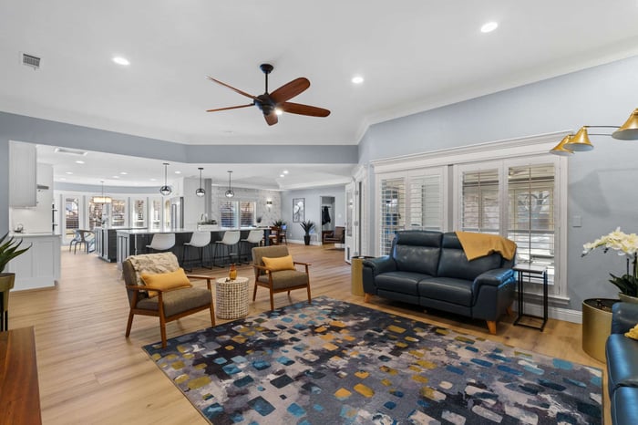 Remodeled living room and kitchen in Frisco, TX with an open floorplan and large kitchen islands