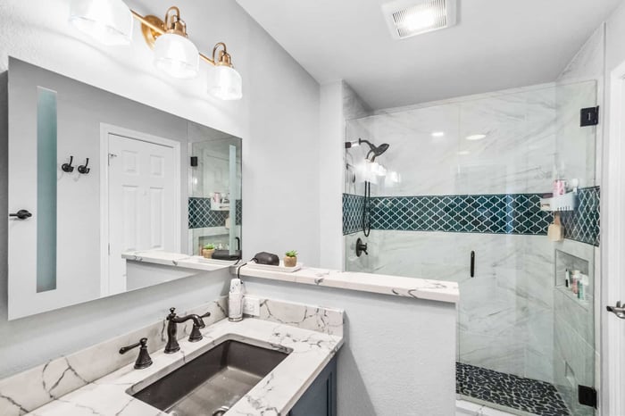 Remodeled guest bathroom in Frisco, TX with a custom walk-in shower