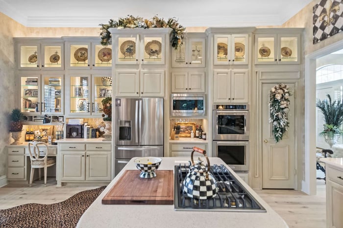 Remodeled kitchen in Frisco, TX featuring cream cabinetry and desk area