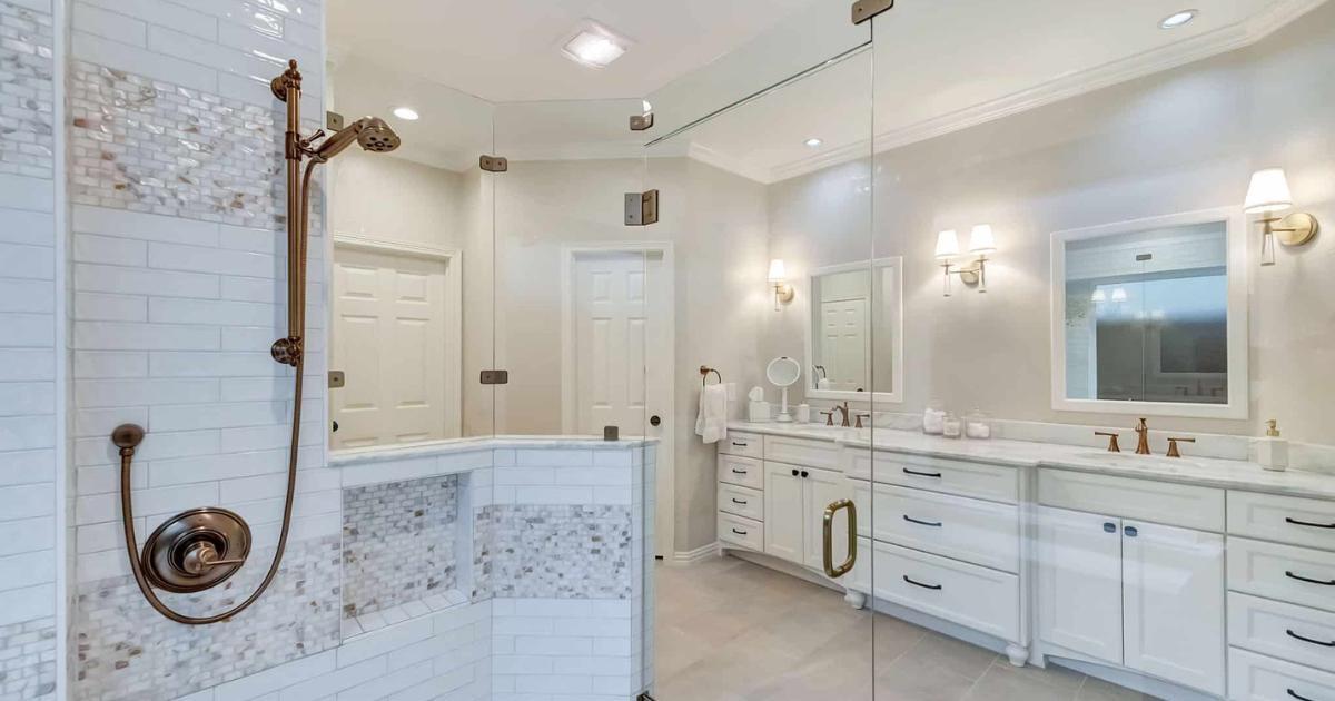 Master bathroom remodel with bronze shower fixtures and bright white design by Elite Remodeling in Frisco, TX