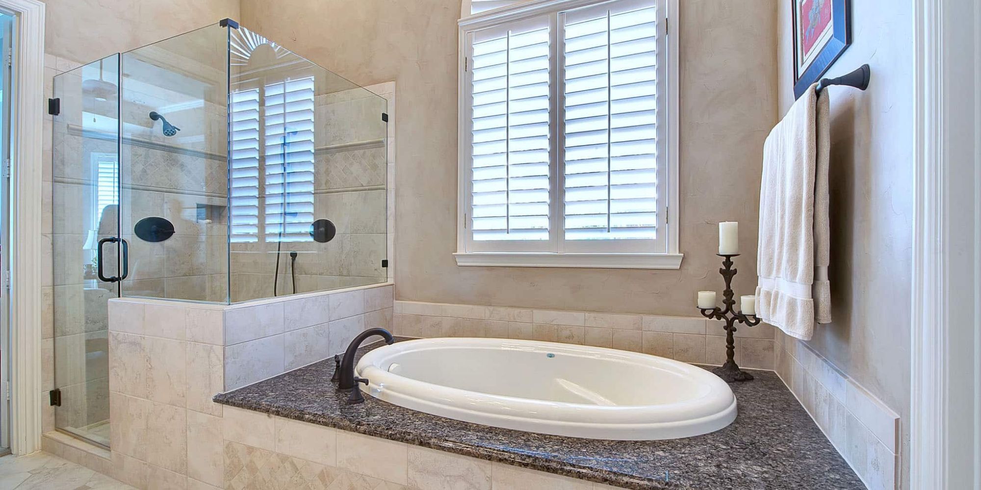 Image of a bathroom remodel with soaking tub and glass walk-in shower in Plano, TX by Elite Remodeling