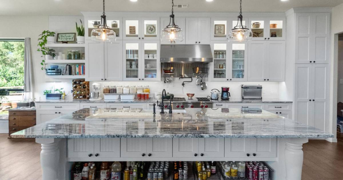 Fully remodeled kitchen with organized pantry storage and display cabinetry