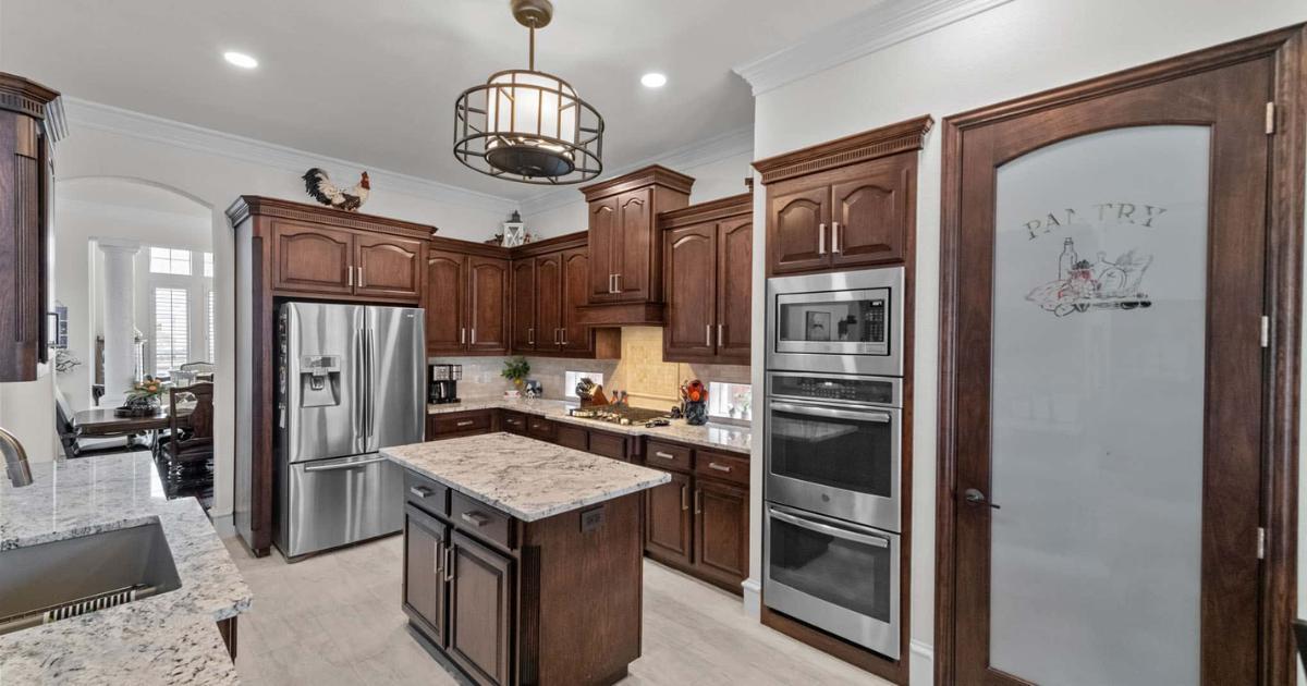 Kitchen remodel with pantry door stainless appliances and island