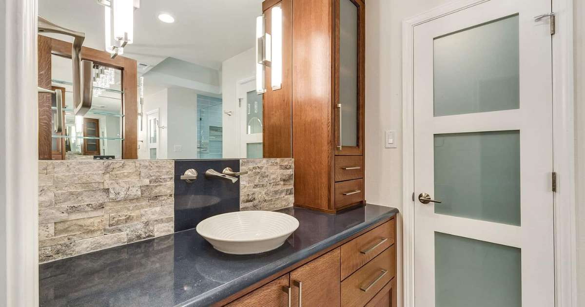 Modern bathroom remodel with sleek fixtures and frosted glass door