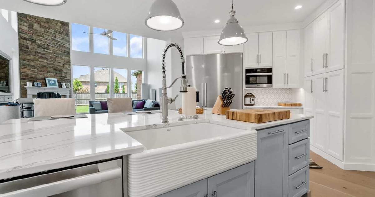Modern kitchen remodel with tall windows quartz tops and custom storage